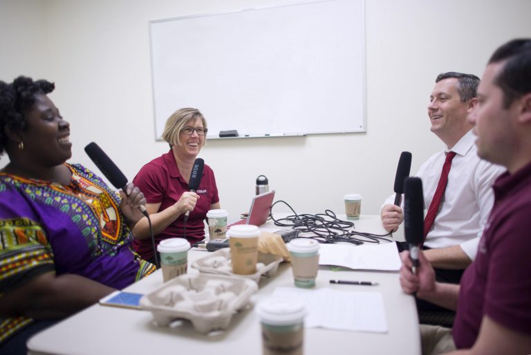 Tracy Butts, Mary Wallmark, Zach Justus, and Aaron Skaggs, (left to right) sit at a table and record the Caffeinated Cats podcast.