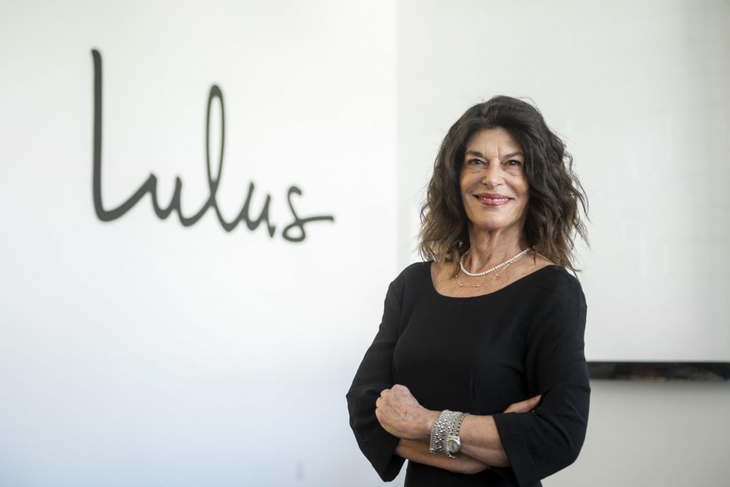 Portrait of Debra Cannon with the Lulus logo behind her.