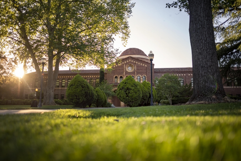 The sun sets behind Kendall Hall.