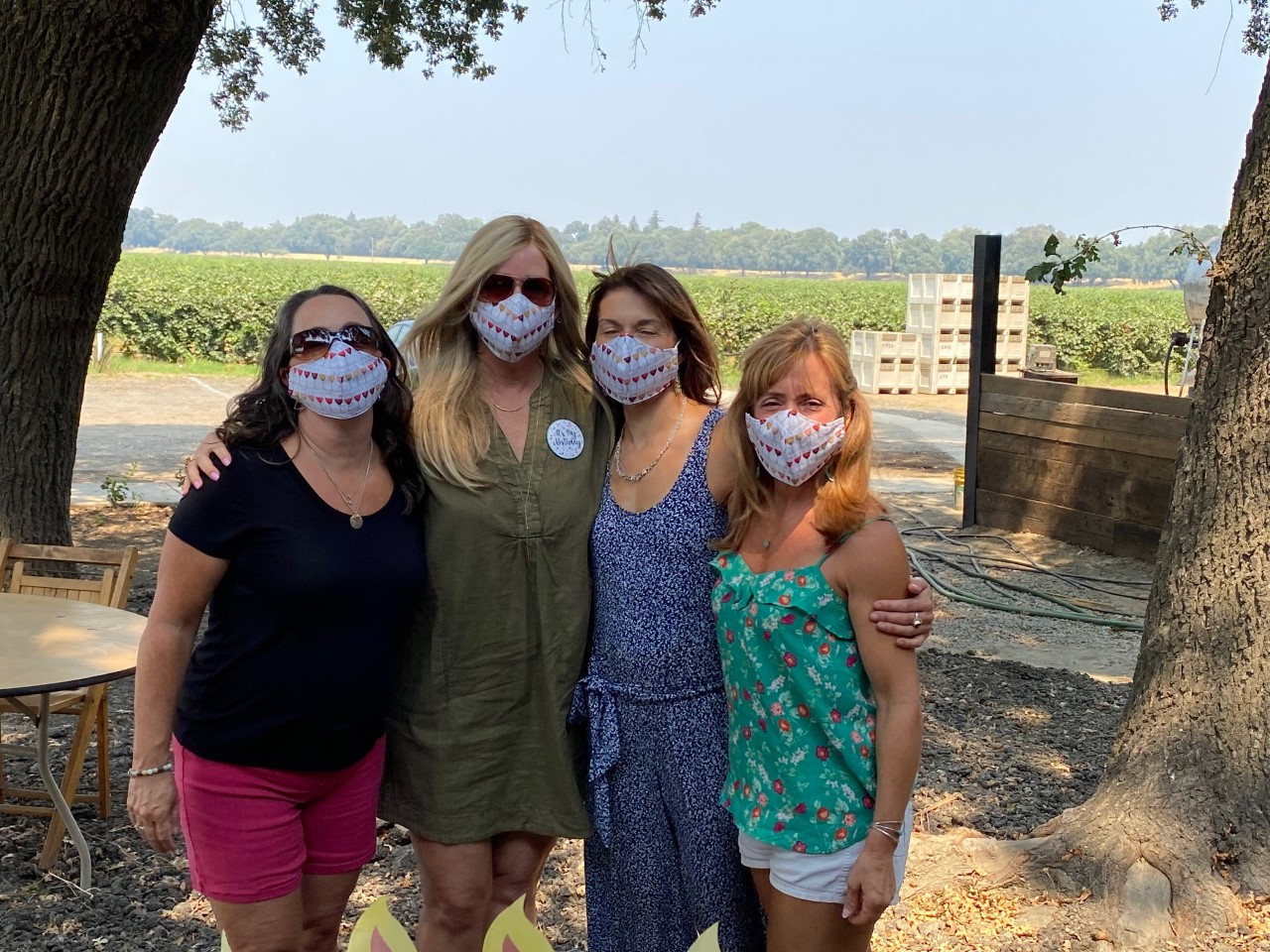 Jennifer Flohr, Fleur Fong, Laurie Dakin and Valerie Robinson stand in their masks at a winery.