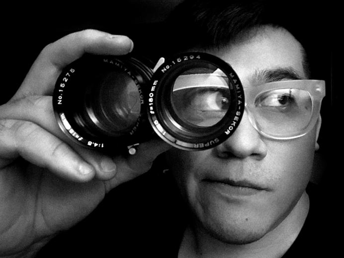 Octavio Valencia looks through a photo lens.