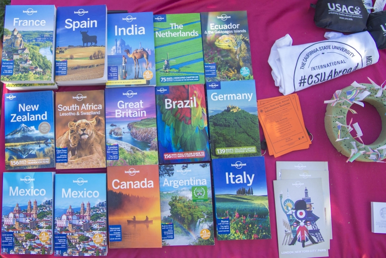 Books highlighting different countries around the world are on a table.