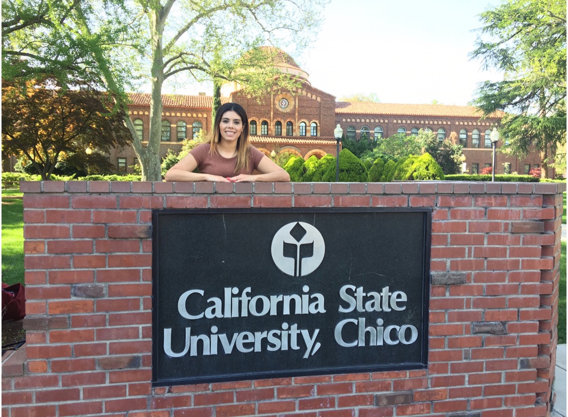 Veronica Ledesma poses standing behind a Chico State sign made of bricks