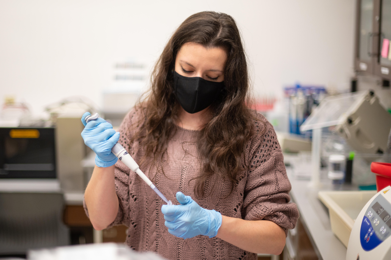 Molly Tuttle uses technology in the lab to prepare samples for RNA extraction.