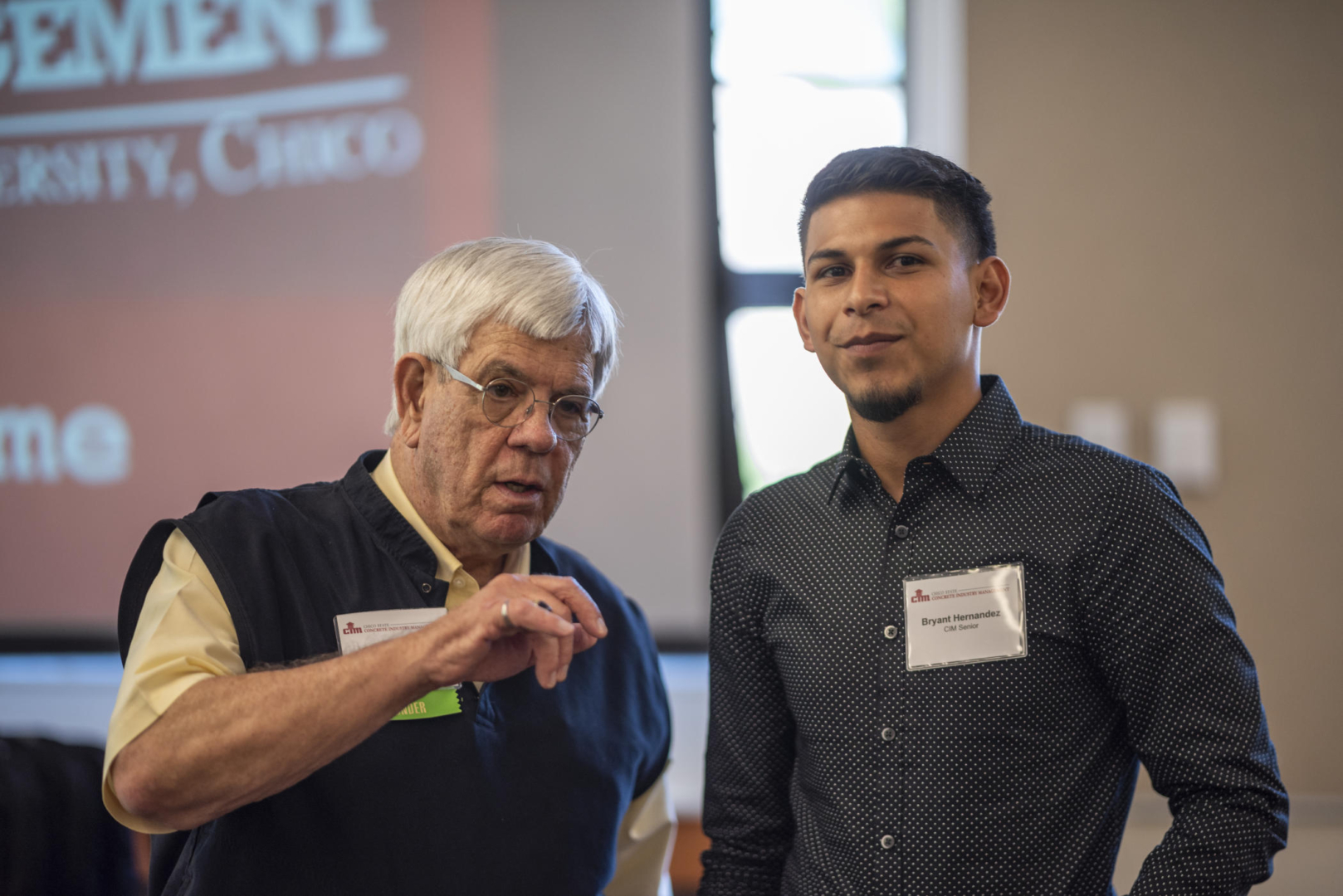 Doug Guerrero talks with a student at a CIM Patrons luncheon.