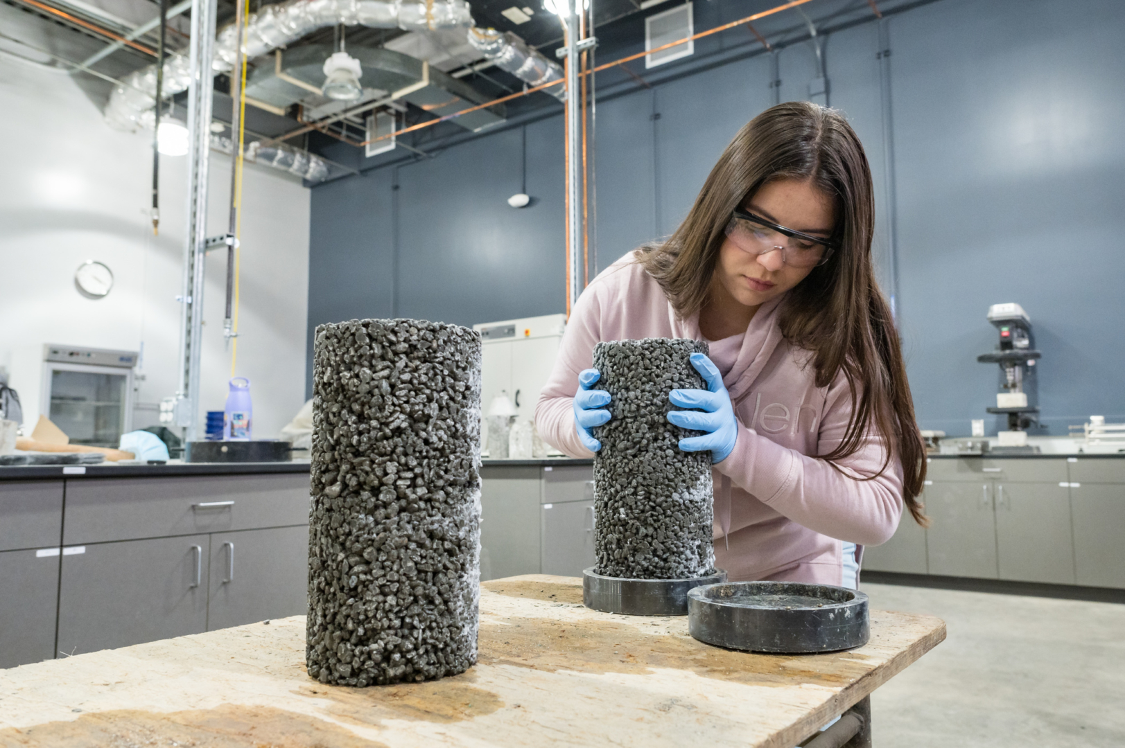 Monica Marin prepares to test concrete columns for integrity in the Concrete Lab.