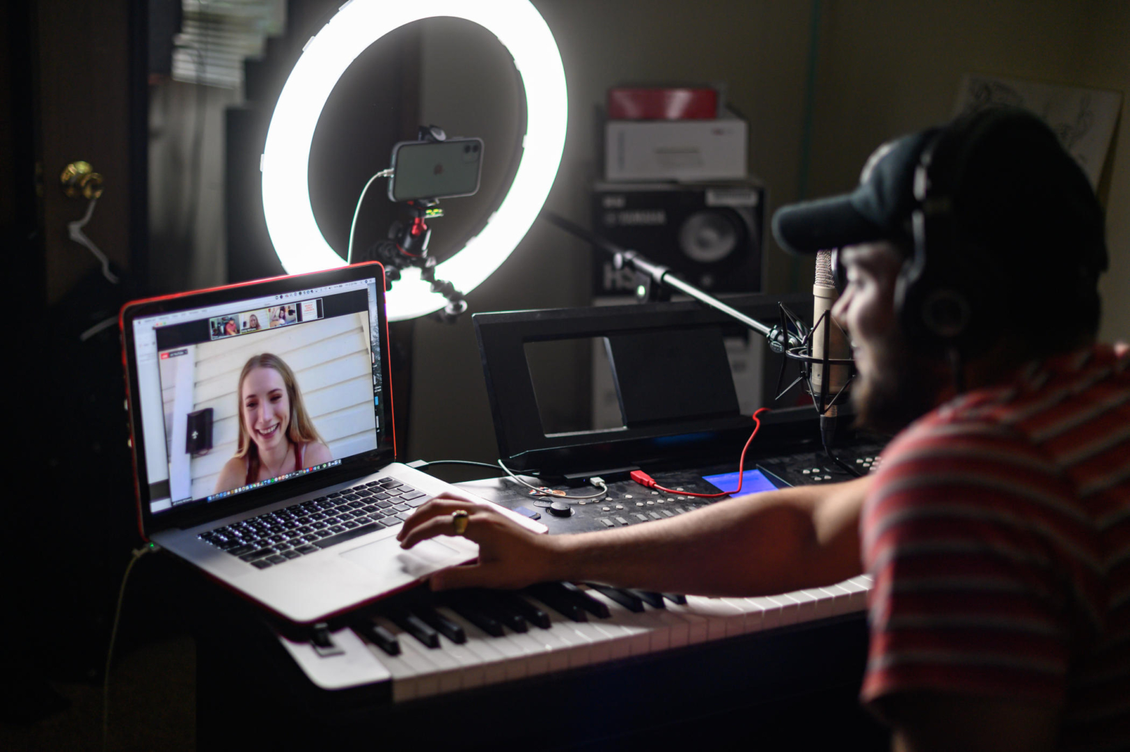 Daniel Hernandez talks to a student via zoom as he is lit up by a Halo light for audio recording.