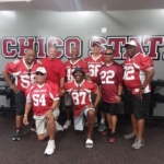 Members of the Chico State football team pose together at a reunion.