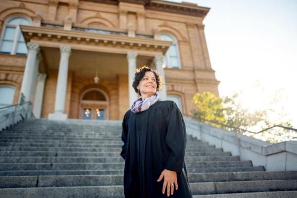 Portrait of Colleen Nichols standing on the steps of a courthouse