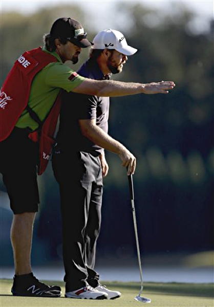 Ryan Moore, right, and caddie J.J. Jakovac  during the final round in the Tour Championship golf tournament in 2012 in Atlanta. 
