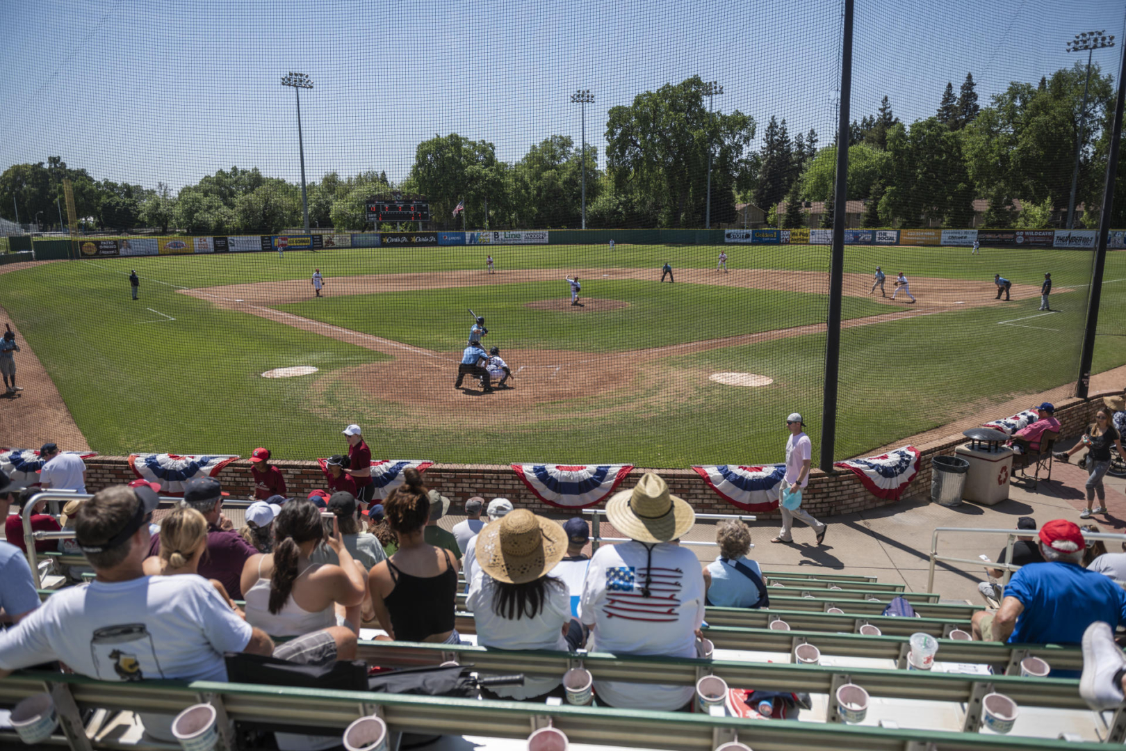Fans sit in the stands at Nettleton Stadium during a baseball game. 
