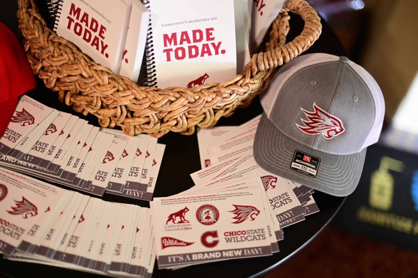 Stickers, hats, and notebooks with the new logos.