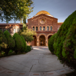 An academic building stands in an early-morning sunshine