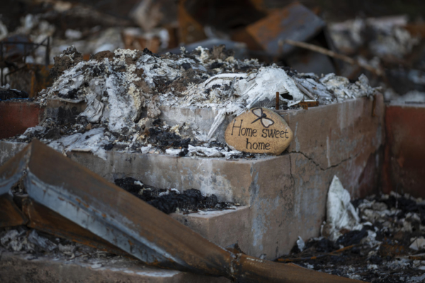A rock decor inscribed "Home Sweet Home" is placed at a destroyed home from the Camp Fire along Newman Avenue in Paradise.