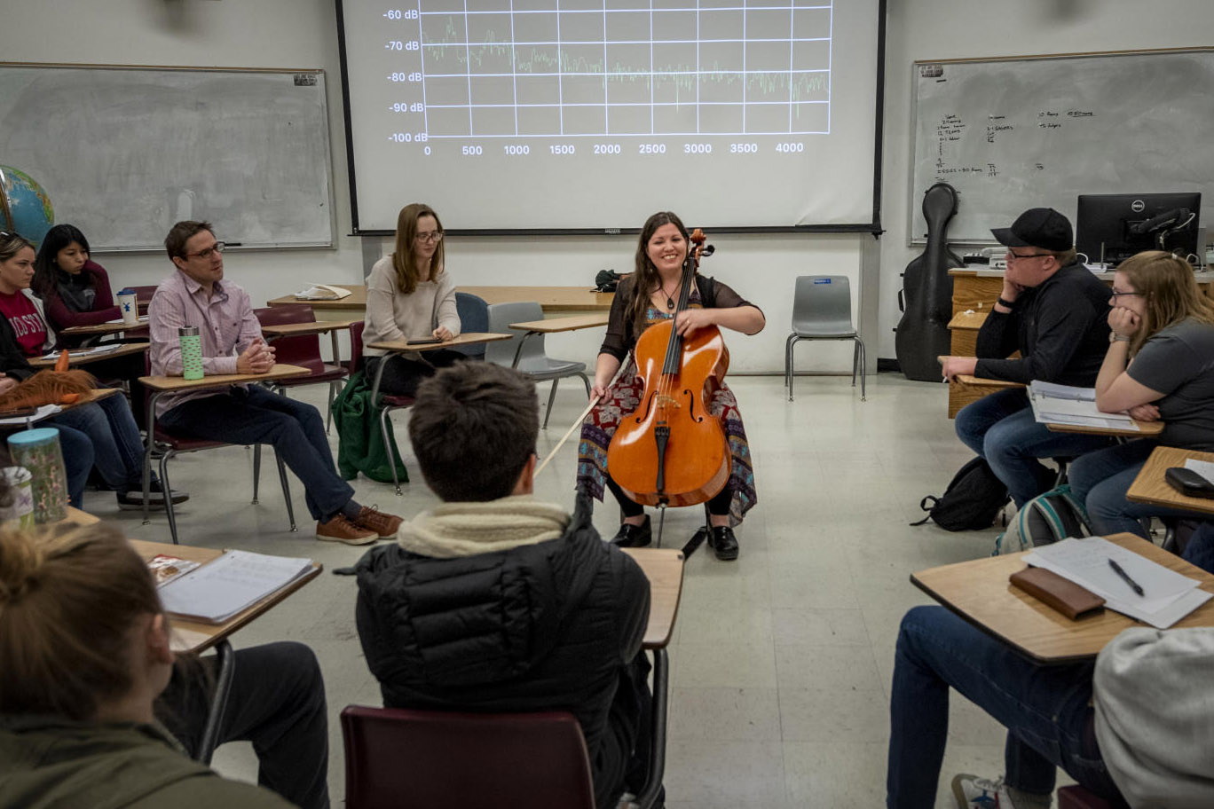 Rebecca Hood plays a cello in a physics class.
