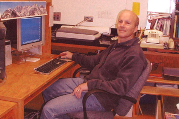 Bill Babb sits at his computer on campus.