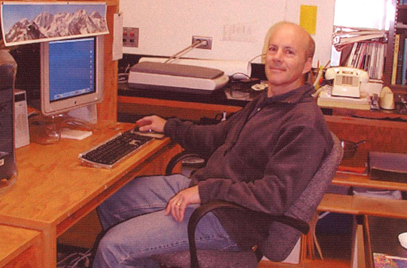 Bill Babb sits at his computer on campus.
