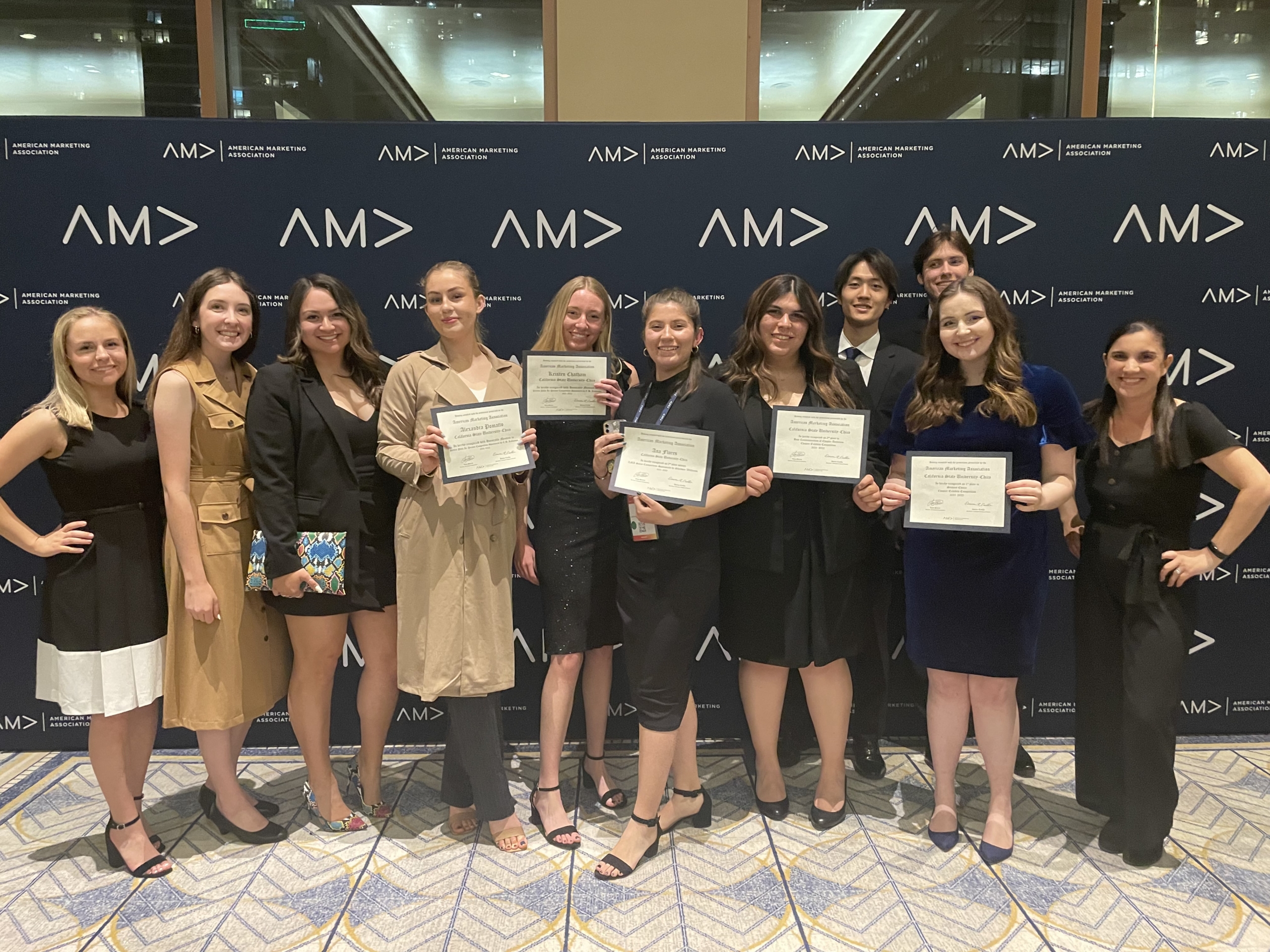 Students stand with their award certificates at the international AMA competition.