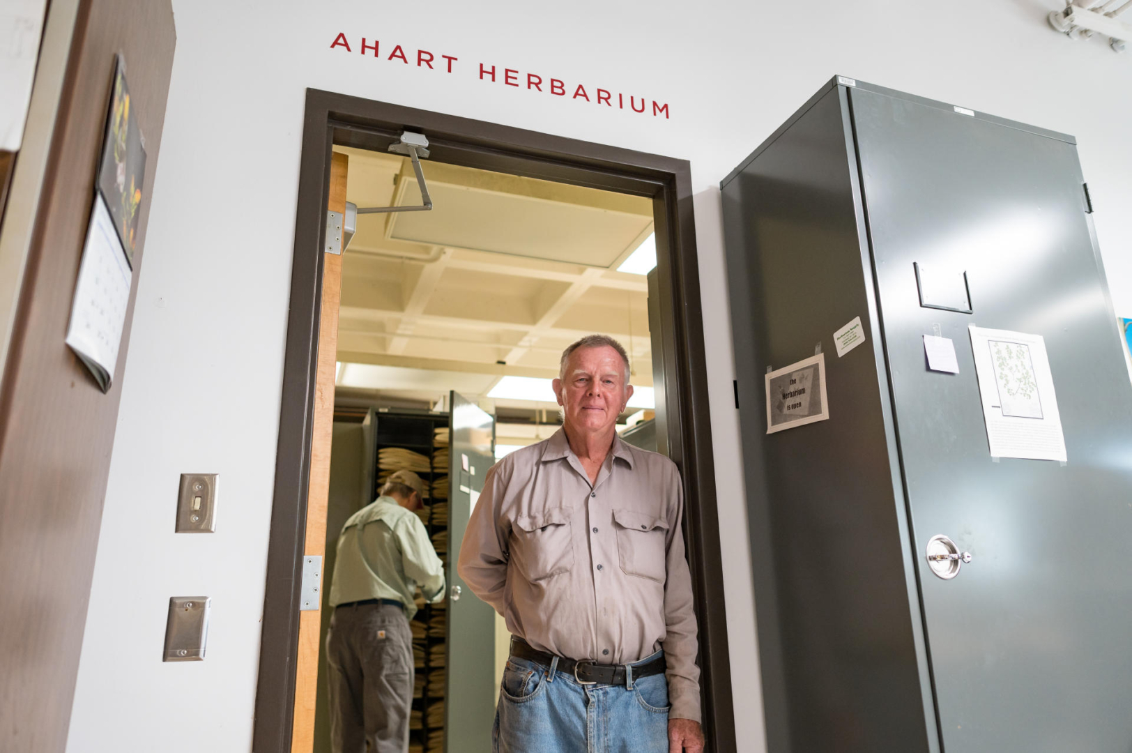 Lowell Ahart stands in the doorway of the Ahart Herbarium, once its new formal name was added above the doorway. 