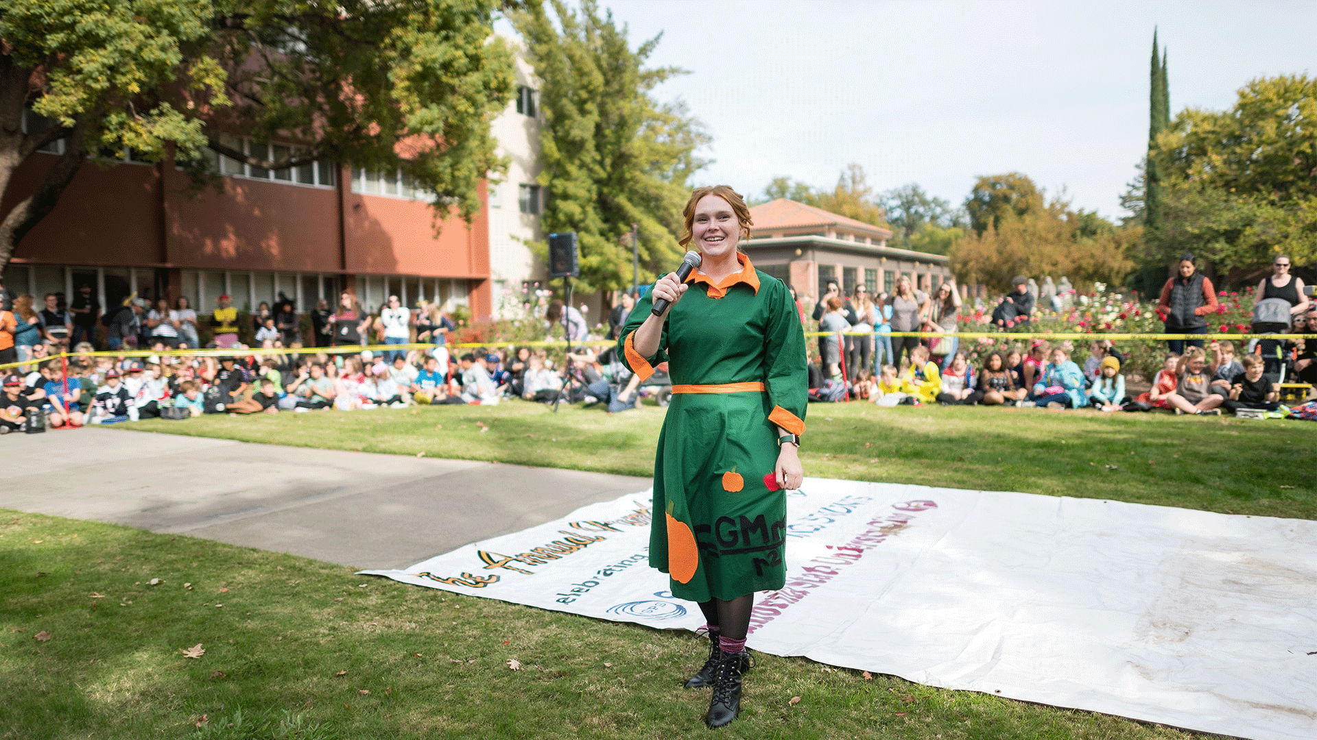 Physics faculty Kendall Hall portrays Ms. Frizzle as local elementary school students watch the Society of Physics students drop pumpkins from a lift during the Annual SPS Pumpkin drop on Monday, October 31, 2022 in Chico, Calif.
