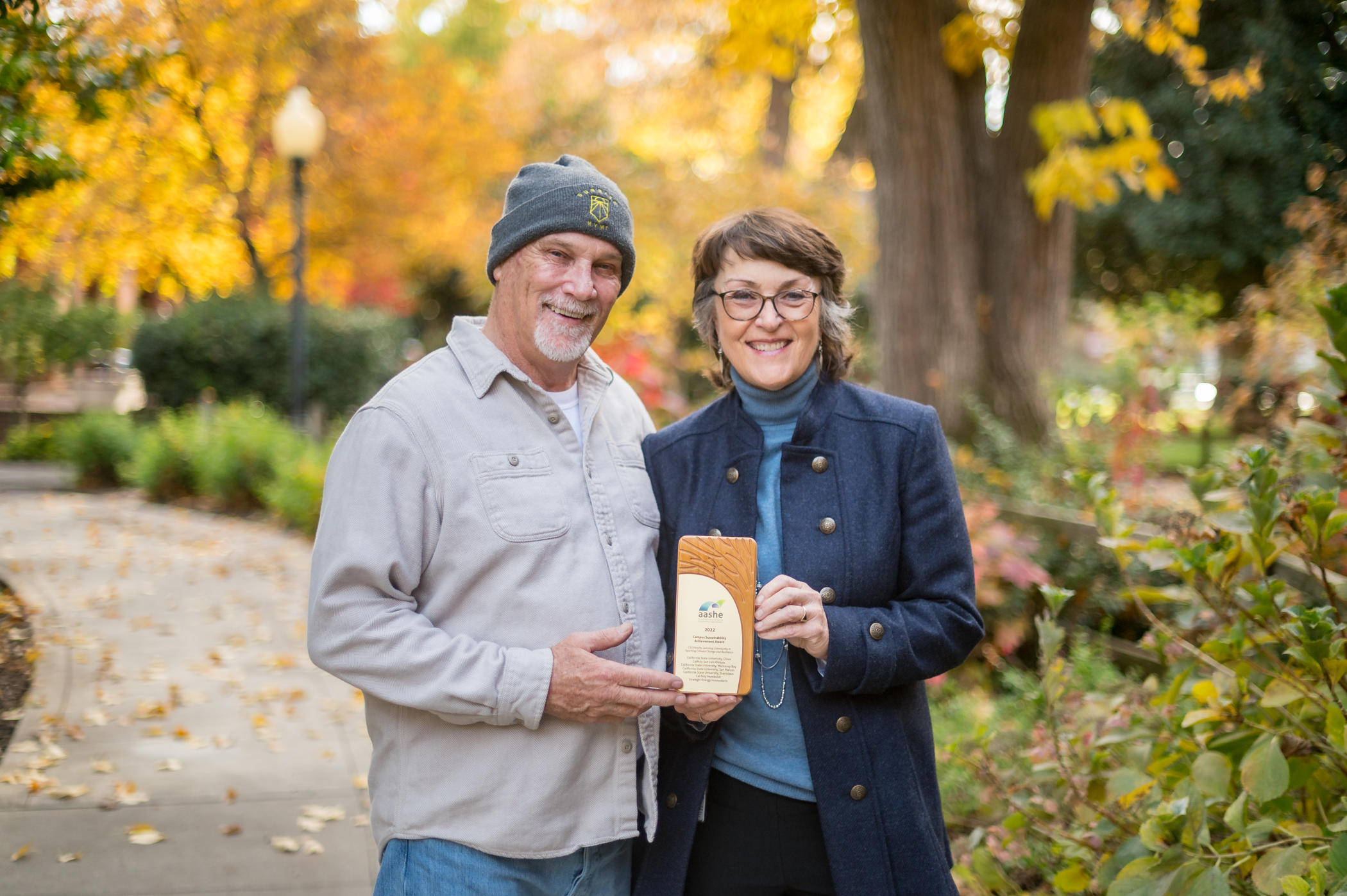 Professor Mark Stemen poses for a photo with Chico State President Gayle Hutchin as they hold the Association for the Advancement of Sustainability in Higher Education (AASHE) Campus Sustainability Achievement Award.