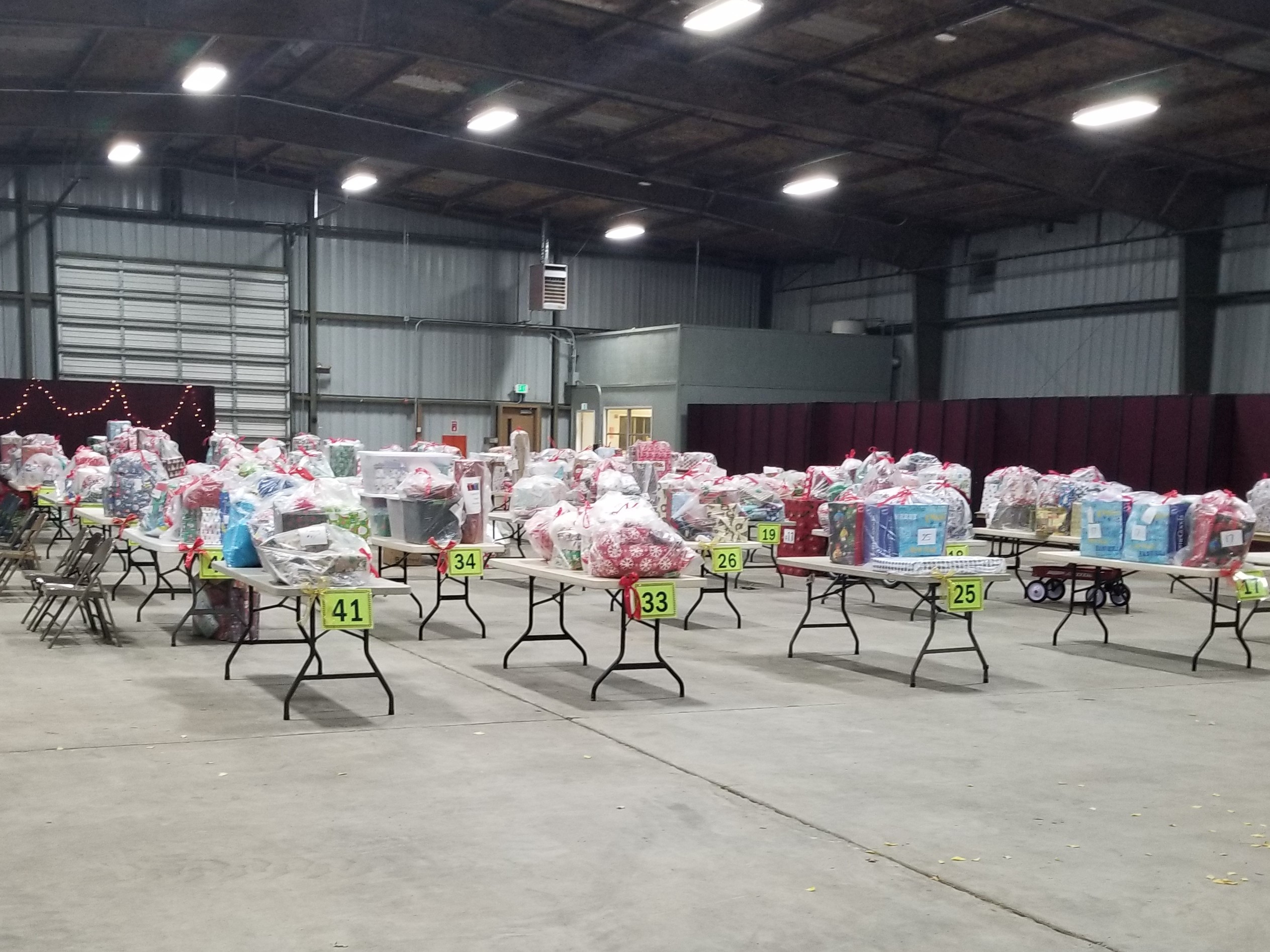 More than a dozen tables are filled with packages of wrapped gifts