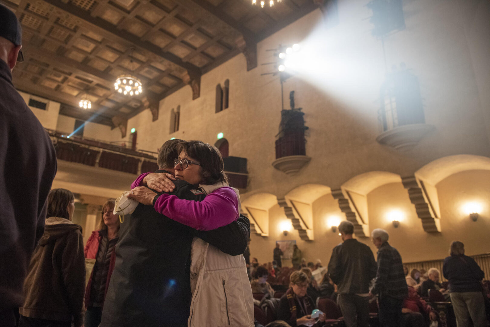 Gayle Hutchinson hugs an individual in the Laxson Auditorium after a community meeting was held two days after the Camp Fire.