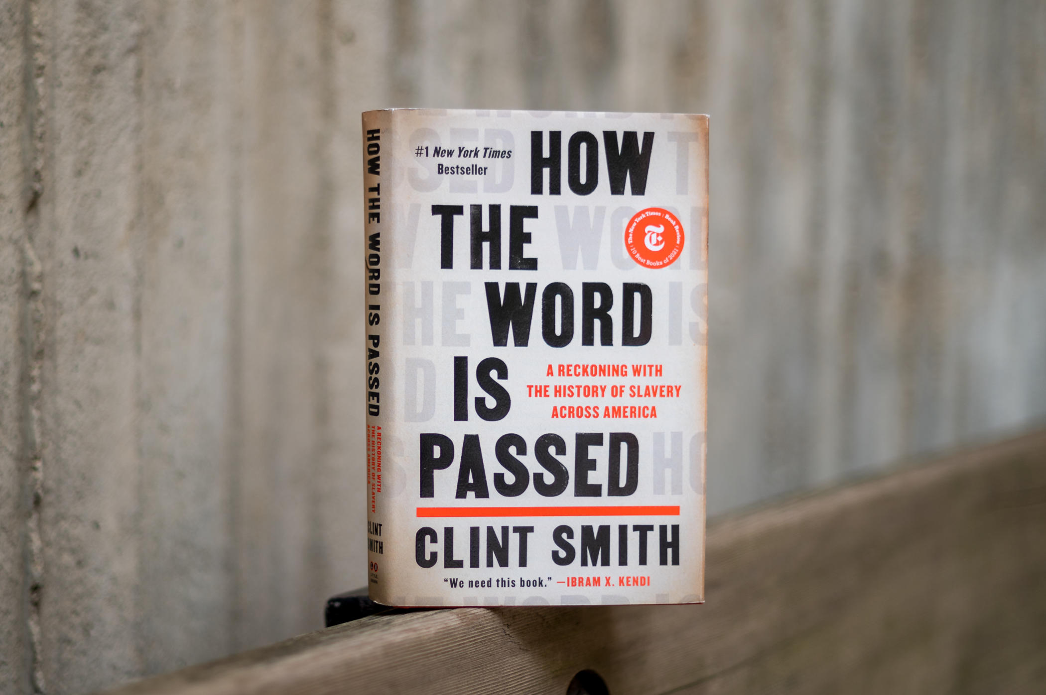 A book, titled "How the Word is Passed," sits on a ledge