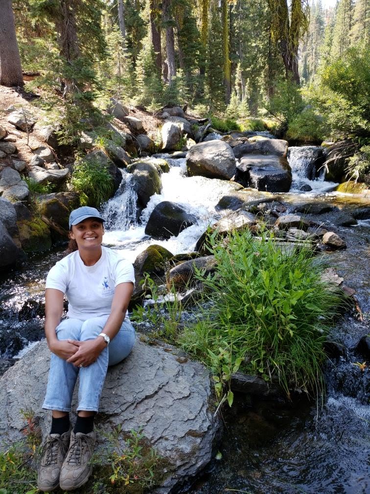 Claire Kooi sits by a gurgling creek