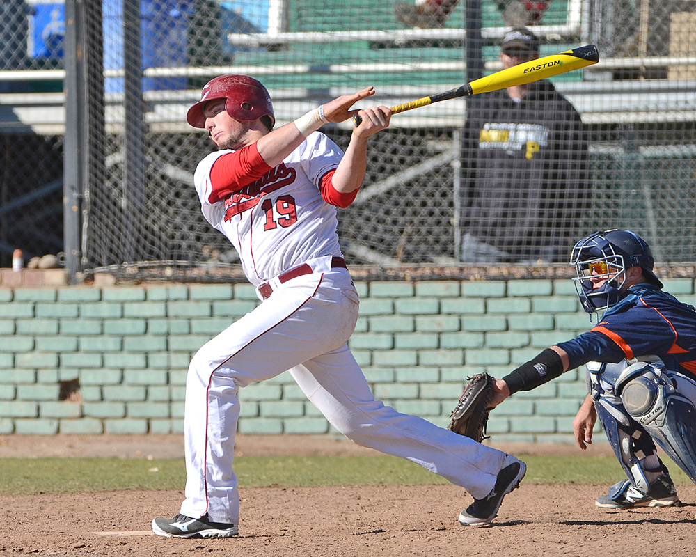 Eric Angerer swings a baseball bat in the right-handed batter's box