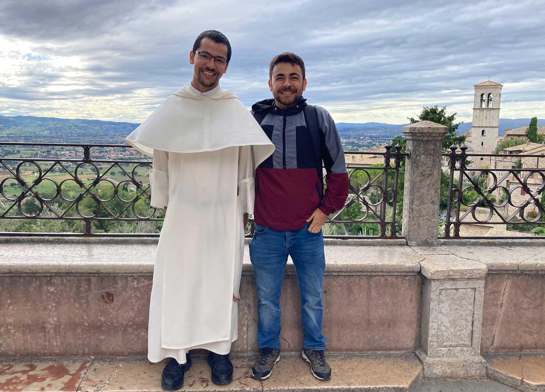 Humberto Partida poses with a priest on a balcony overlooking the city of Florence, Italy.