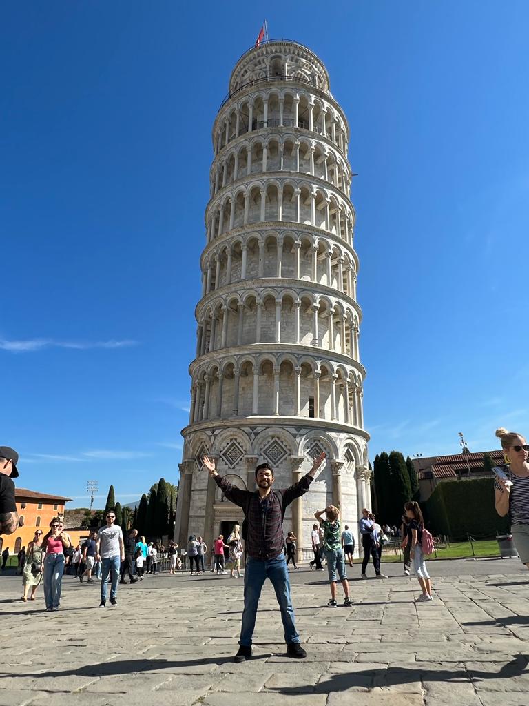 Humberto Partida poses in front of the Tower of Piza in Piza, Italy.
