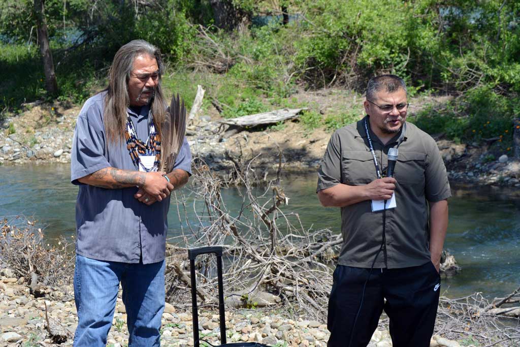 Joseph James, Chairman of the Yurok Tribe (right) speaks as and Arthur Garcia, Cultural Resource Manager and Tribal Elder of the Wintu Tribe, looks on. The Kapusta 1B project, a new Sacramento River side channel approximately ½ mile long (2,365 feet) created for salmanoid spawning habitat is behind them.