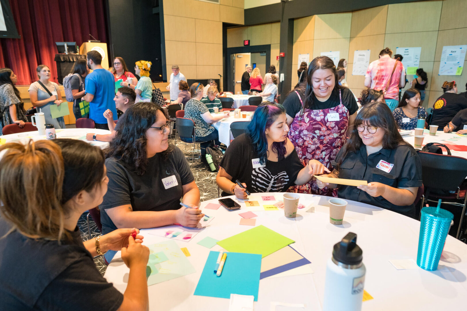 Students Andrea Grijalva, Valerie Barragan, Melissa Garibay, Marisol Marquez, and Naomi Gomez (left to right) sit at a table working together on an activity while attending a professional development event as part of the NorCal GREAT Teachers Pipeline.