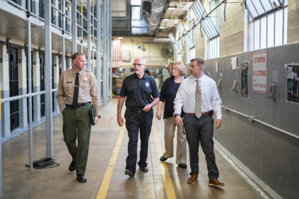Capt. Keith Michels, Rory Thelen, Nancy Thelen, Lt. Chad Deal (left to right) take a tour of one of the buildings that houses inmates at Folsom prison.
