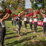President Steve Perez runs through Expressions Dance team with raised pom poms as the campus community enjoys the Alumni and Family Weekend BBQ barbecue as part of Wildcat Weekend