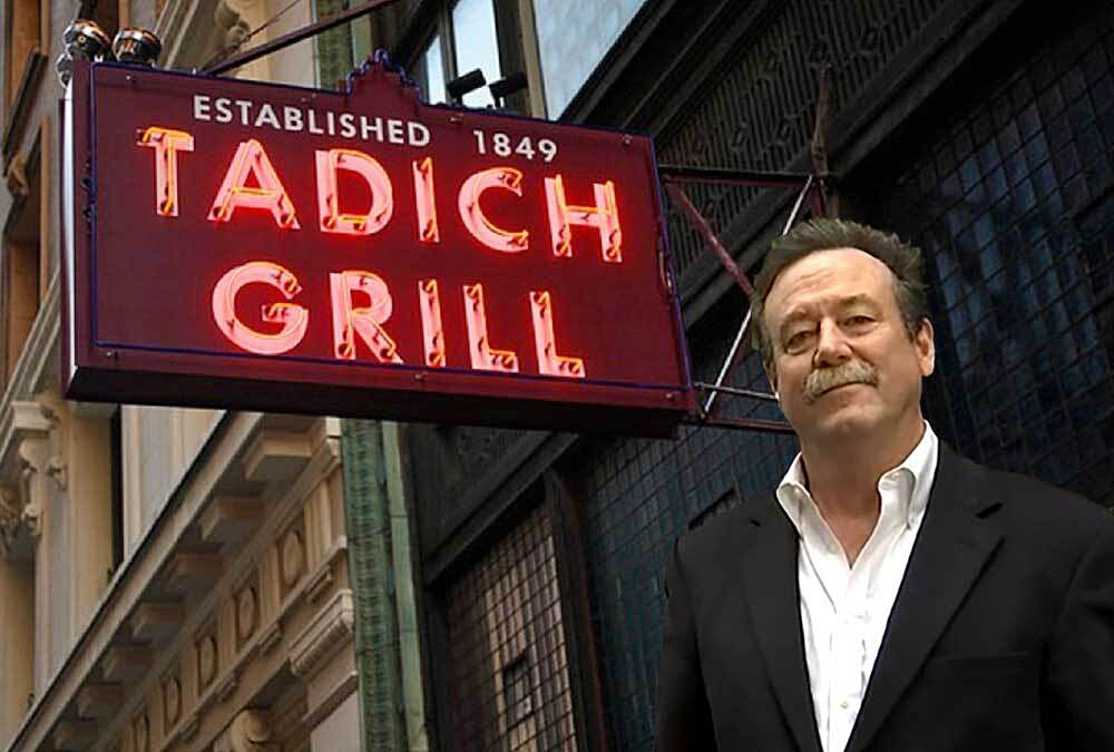 A neon sign that says Tadich Grills is lit up outside the restaurant storefront.