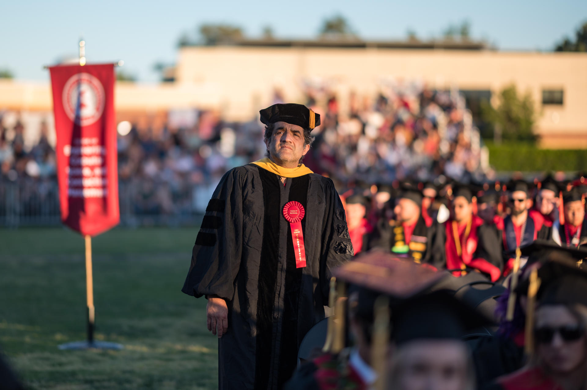 Jaime Raigoza stands at a Commencement ceremony