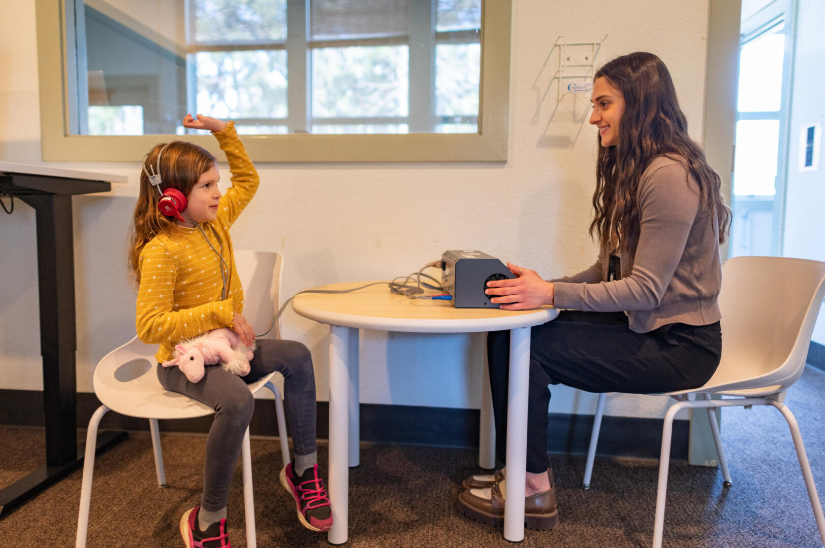 Genevieve Martin (left) undergoes a hearing test from CMSD student Jonelle Agelopoulos (right) during a Clinic Communication for Disorders counseling session at Chico State.