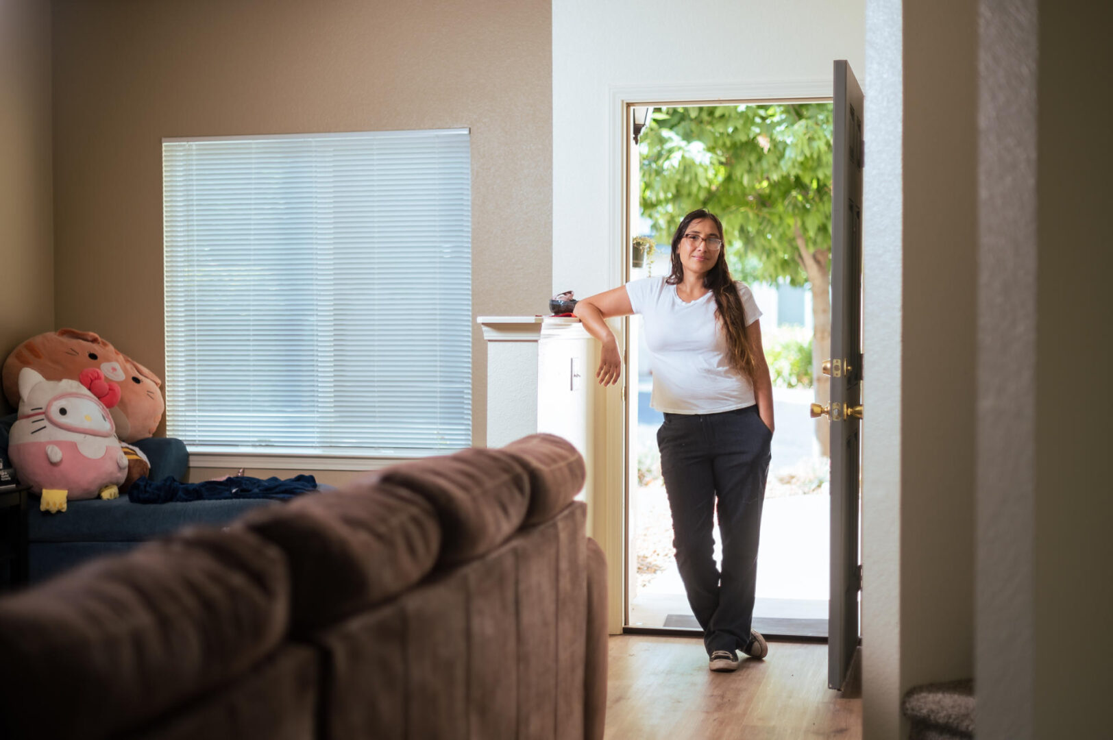 Veronica Aguilar stands in the doorway of her apartment. 