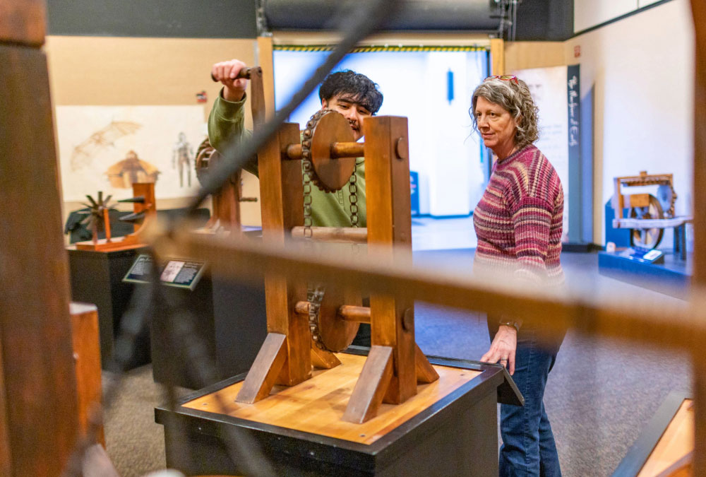 Jeanne Greene (left) and William Henriquez (right) explore the Leonardo da Vinci: Machines In Motion exhibit at the Gateway Science Museum.