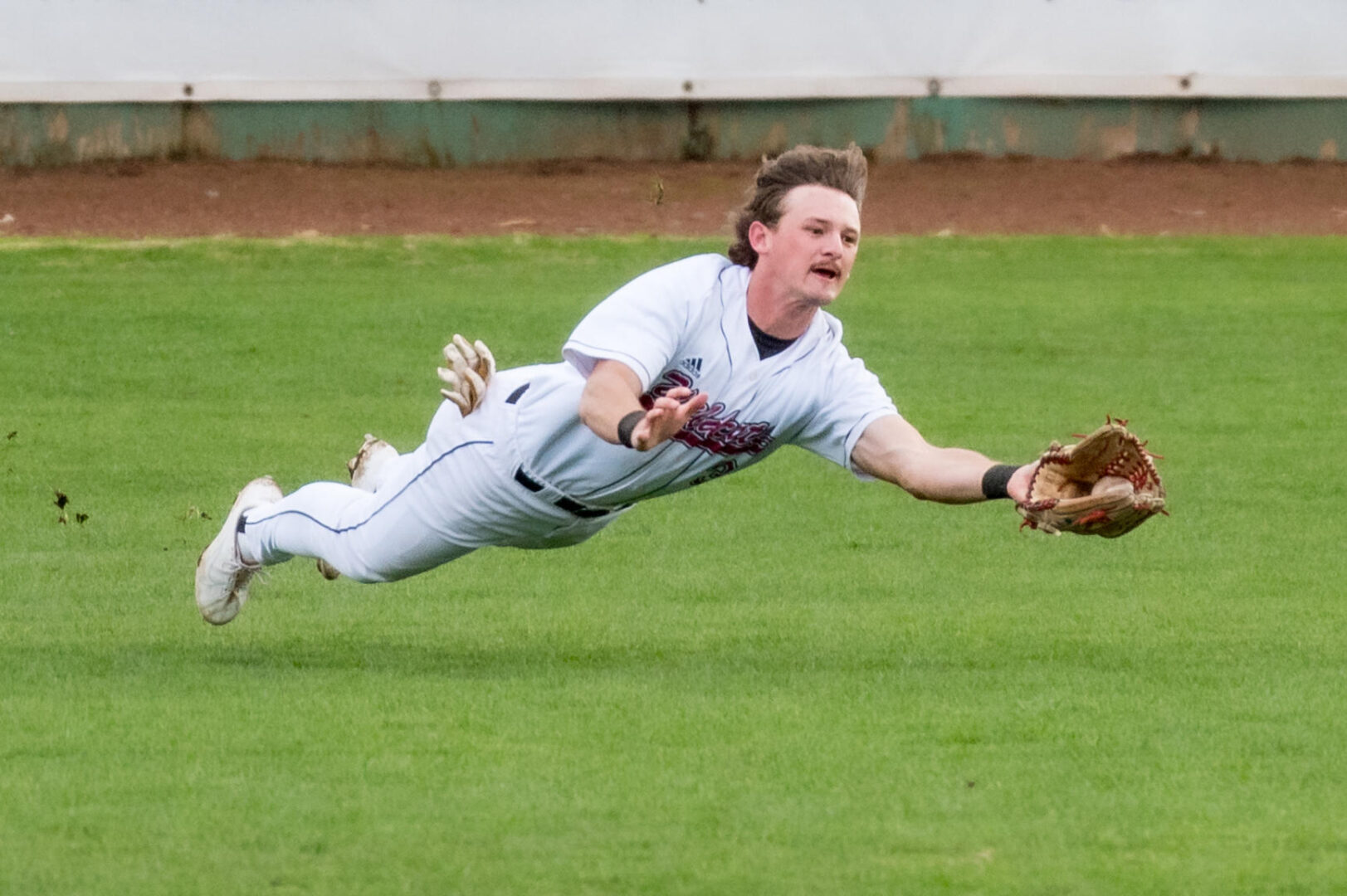Chico State baseball outfielder Troy Kent makes a diving catch.