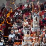Brandy Huffhines rises to shoot over a leaping defender in this artistic double-image photo.