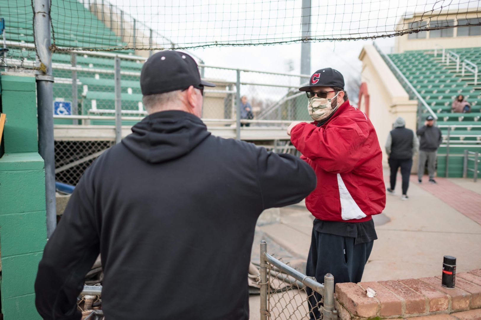 Chico State baseball superfan John Brownell shares an elbow bump with Head Coach Dave Taylor following the Wildcats' season-opening 14-2 victory.