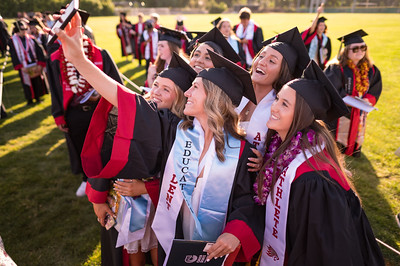 Students pose for a photo during the College of Communication and Education Graduation Ceremony.