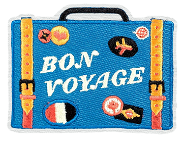 A patch of a suitcase with the words Bon Voyage.