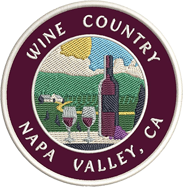 A patch that reads: "Wine Country Napa Valley, CA" and depicts two glasses of wine and a bottle in the foreground, as well as a depiction of a vineyard in the background.