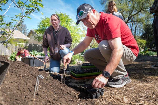 President Perez digs in the soil at a community improvement event.