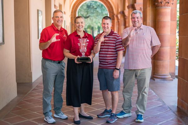 President Steve Perez, Executive Athletic Director Anita Barker, Assistant Athletic Director Brian Ceccon, and Faculty Athletic Representative Matt Thomas (left to right) take a group photo as the California Collegiate Athletic Association (CCAA) awarded Chico State Intercollegiate Athletics with the 2023-24 Robert J. Hiegert Commissioner's Cup.
