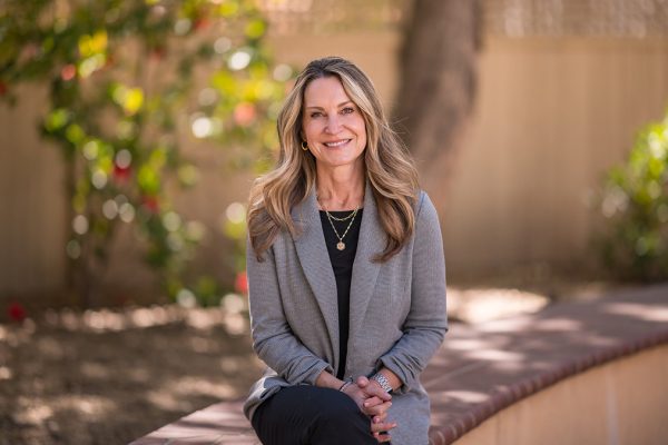 Chico State Alumni Board President Kristen Schrock sits with her hands in her lap, posing for a headshot on campus at the University.